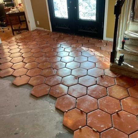 Terracotta hexagonal tile laid across an entrance hall floor